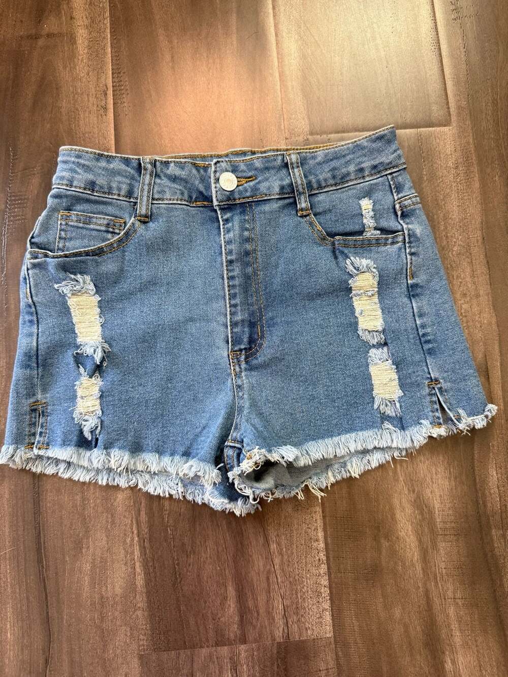 High-Waisted Distressed Raw Hem Denim Shorts in Light Blue